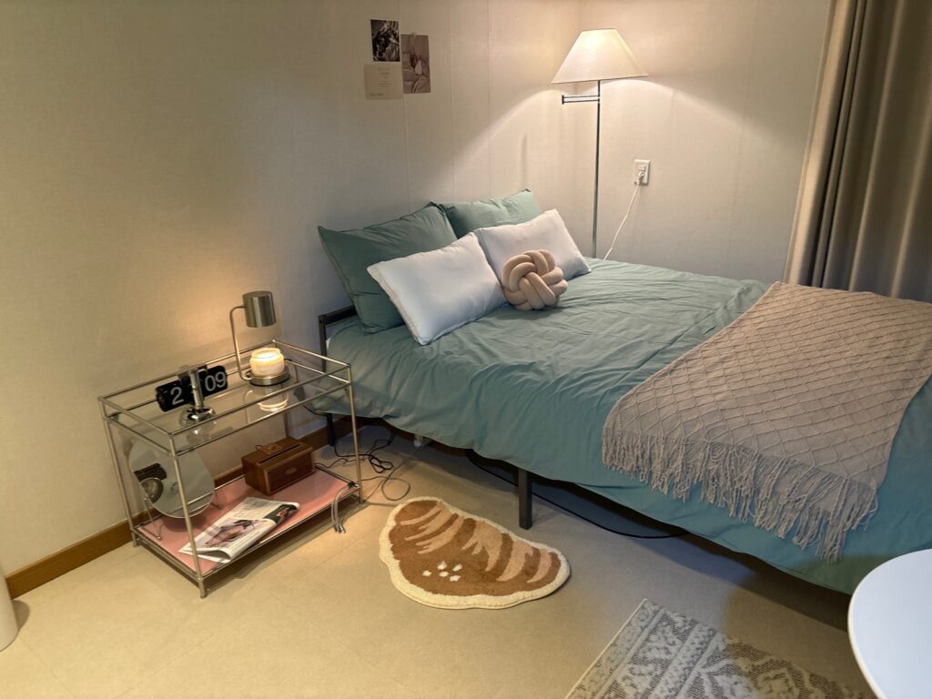 Beige and dusty pink bedroom with grey systemic closets showing 94% Airbnb occupancy using warm neutral colour palette and Coolors.co design method