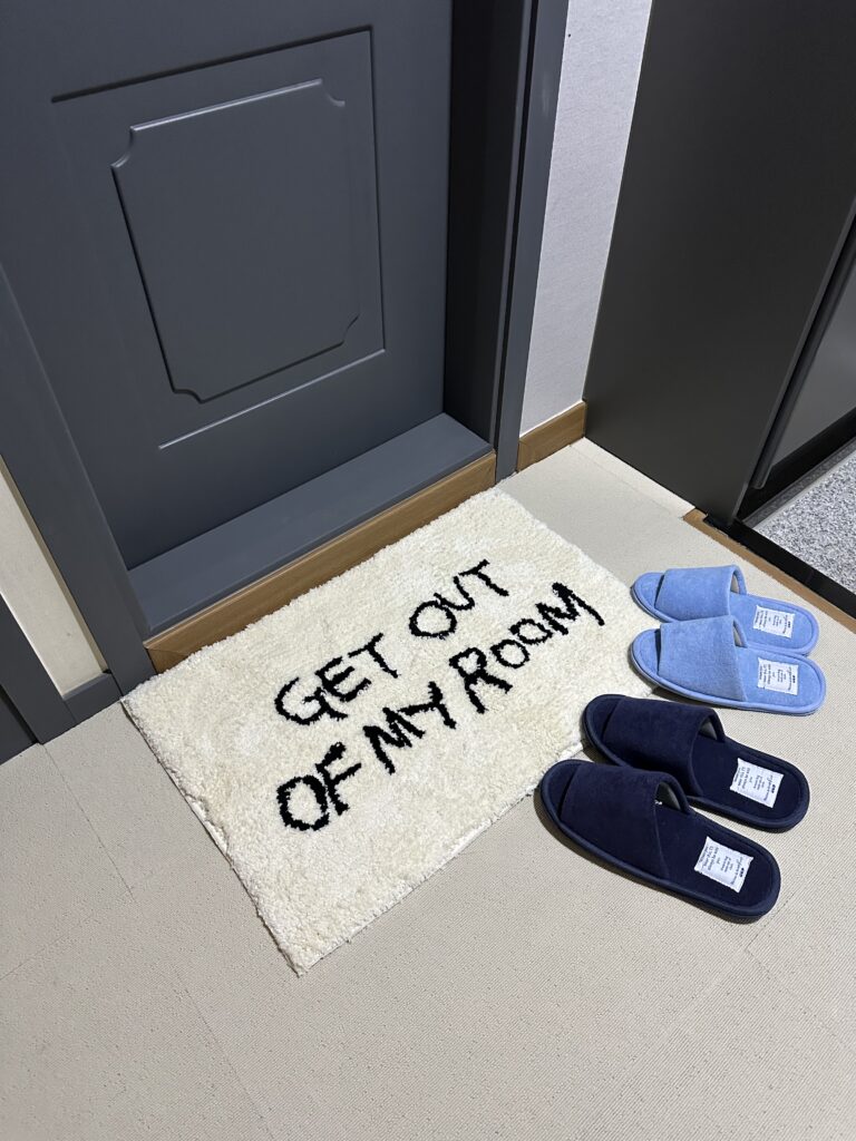 Ballet core Airbnb bedroom entrance with terrazzo tile carpet and whimsical pastel blue design