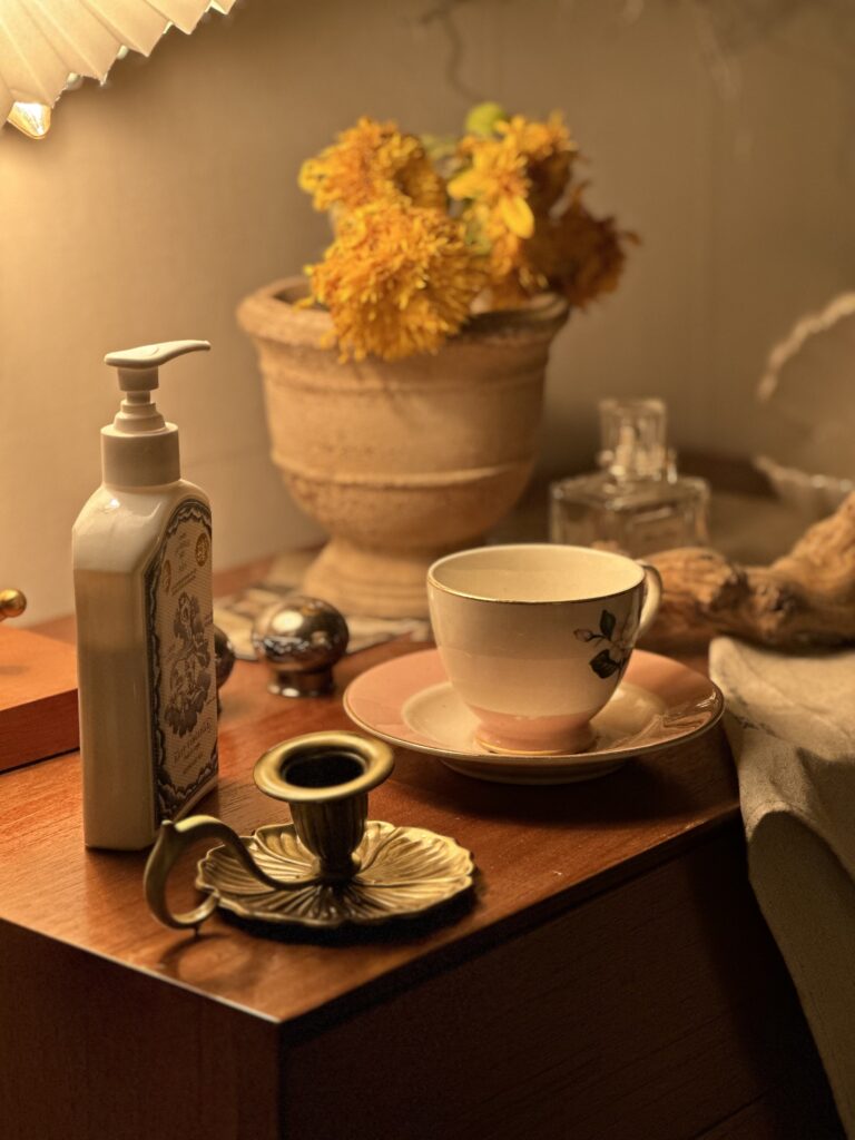 Perfume bottle and lotion in BPD-friendly bedroom creating calming aromatherapy ambiance