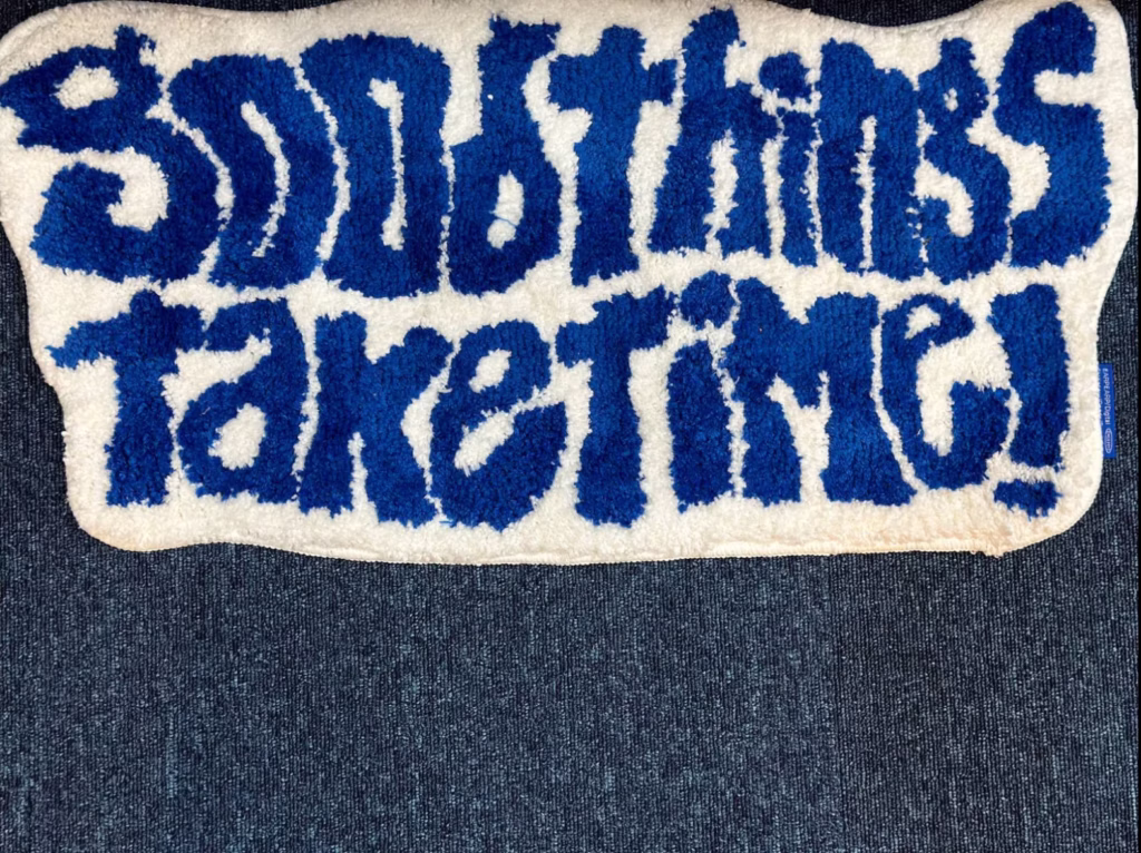 Navy blue carpet with bathroom rug